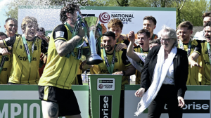 AFC Fylde skipper Corey Whelan accepts the trophy