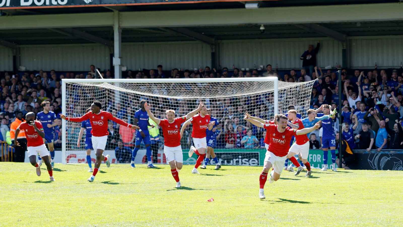 York City players wheel away in jubilation after Josh Stones squeezes in their winner