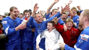 Accrington Stanley players celebrate winning promotion to the Football League
