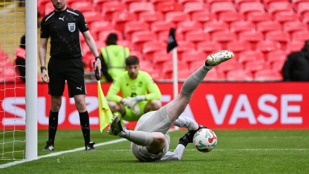 AFC Stoneham keeper Callum Lee saves during the penalty shootout that sealed FA Vase glory for the Purps