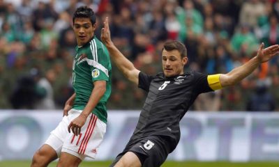 Tommy Smith, of New Zealand, lunges to thwart Mexico’s Raul Jimenez during a 2014 World Cup play-off game