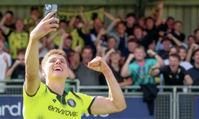 Harrogate Town striker Ciaran McGuckin celebrates his double with a selfie in front of the supporters