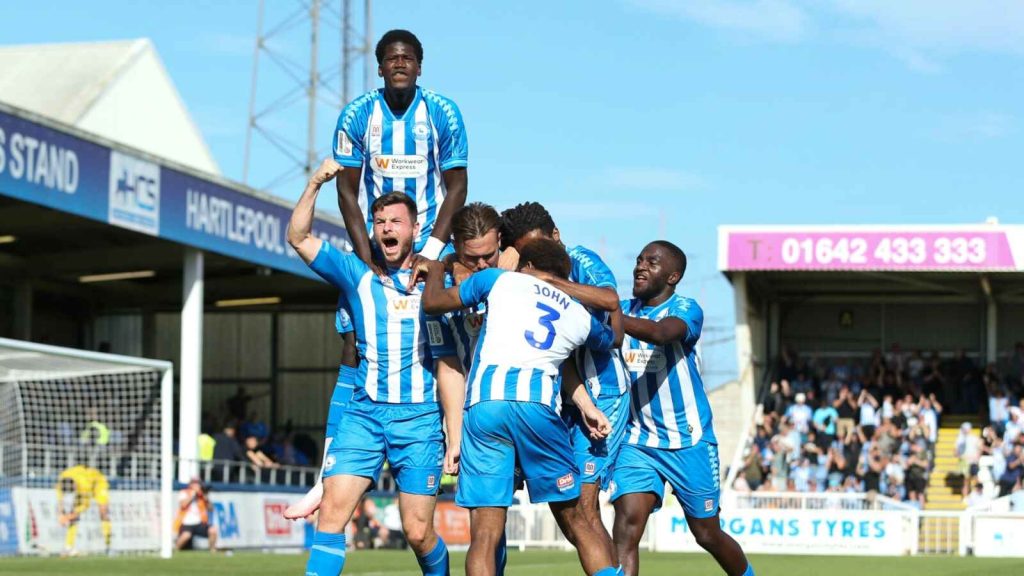 Hartlepool United’s players celebrate their 2-0 opening-day victory over Barrow in front of a buoyant Victoria Park crowd.