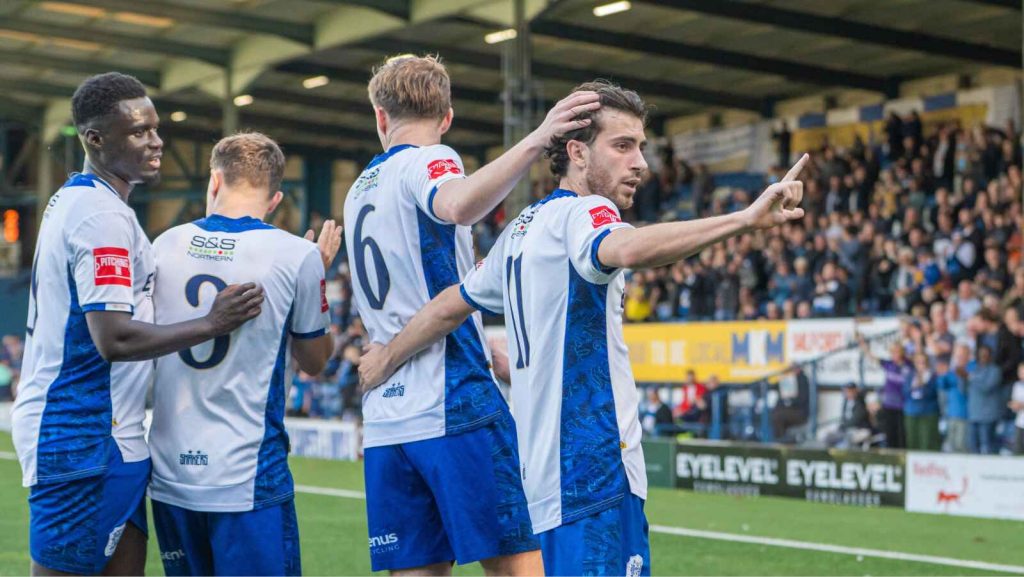 Bury players celebrate during their FA Trophy third qualifying round triumph over Gainsborough Trinity.