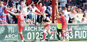 DRAMA: Jack Barham wheels away after his late winner handed Aldershot Town victory over rivals Woking PICTURE: Ian Morsman