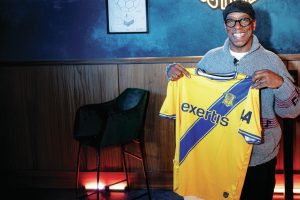 A WRIGHT TOUCH: Ian Wright holds aloft the specially-made Basingstoke Town shirt