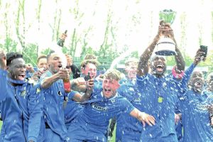 TASTE OF SUCCESS: Bedford Town’s players celebrate their most unlikely of title victories in Southern League Premier Central PICTURE: Mike Capps