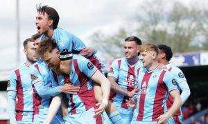 MOBBED: Danny Whitehall celebrates with his Scunthorpe United team-mates PICTURE: Luke Broughton