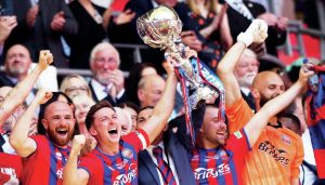 LOUD ‘N’ PROUD: Aldershot Town’s players collect the FA Trophy to the roar of the Wembley masses PICTURES: Alamy and Peter Short