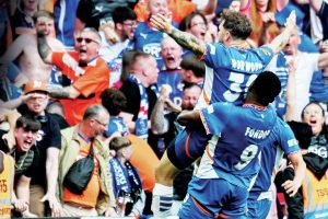 LAPPING IT UP: James Norwood celebrates his extra-time equaliser to make it 2-2 and parades the trophy with Mike Fondop, below PICTURES: Garry Griffiths & Alamy