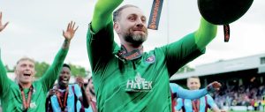BOWING OUT IN STYLE: Goalkeeper Ross Fitzsimons holds aloft the National League North Play-Off trophy with Scunthorpe United PICTURE: Luke Broughton