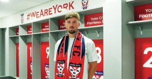 HOME COMFORTS: Alex Newby settles into his new surroundings in the York City dressing room PICTURE: York City FC