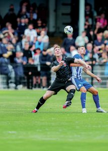 Eyes on the prize: Chorley’s Mark Ellis, left, battles with Wigan’s Paul Mullin                                                Picture: David Airey