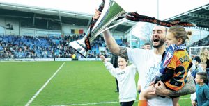 CHAMPION: Ollie Banks holds aloft the National League trophy with Chesterfield PICTURE: Alamy