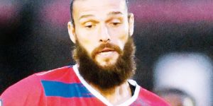 NATURAL HABITAT: Andy Carroll in action for Dagenham & Redbridge, and, inset below, with fans after the game PICTURE: Arfa