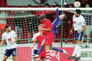 AWAY! Ashton United’s Sean Newton heads clear as FC Halifax Town failed to find a way through PICTURE: Alun Roberts