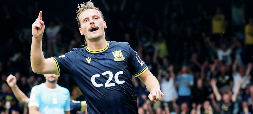 MAKING HIS POINT: Scott-Morriss enjoys scoring his side’s second goal PICTURE: Focus Images