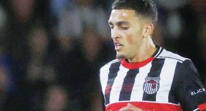 STEPPING IT UP: Jaze Kabia against Man Utd and inset, celebrating for Truro City PICTURE: Alamy