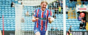 Luke Armstrong wheels away in delight after scoring Carlisle’s opening goal