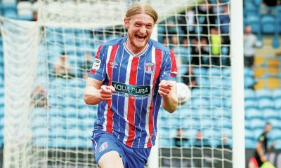 Luke Armstrong wheels away in delight after scoring Carlisle’s opening goal