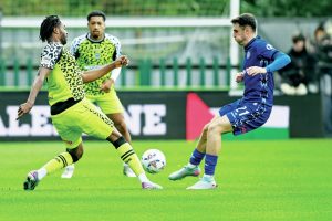 Forest Green’s James Balagizi, left, gets to the ball before Rochdale’s Connor McBride