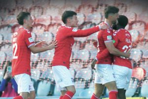 Alex Newby, centre, takes the plaudits from York team-mates Joe Felix and Alex Hunt