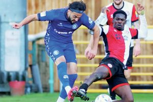 Rochdale’s Tarryn Allarakhia is challenged by Woking’s Timmy Akinola