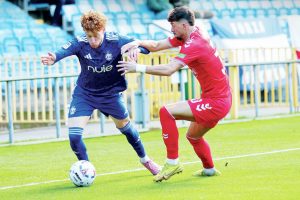 Owen Bray, left, takes on York City’s Alex Newby