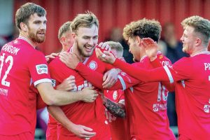 Worthing teammates congratulate defender Joe Cook on his wonder goal