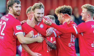 Worthing teammates congratulate defender Joe Cook on his wonder goal