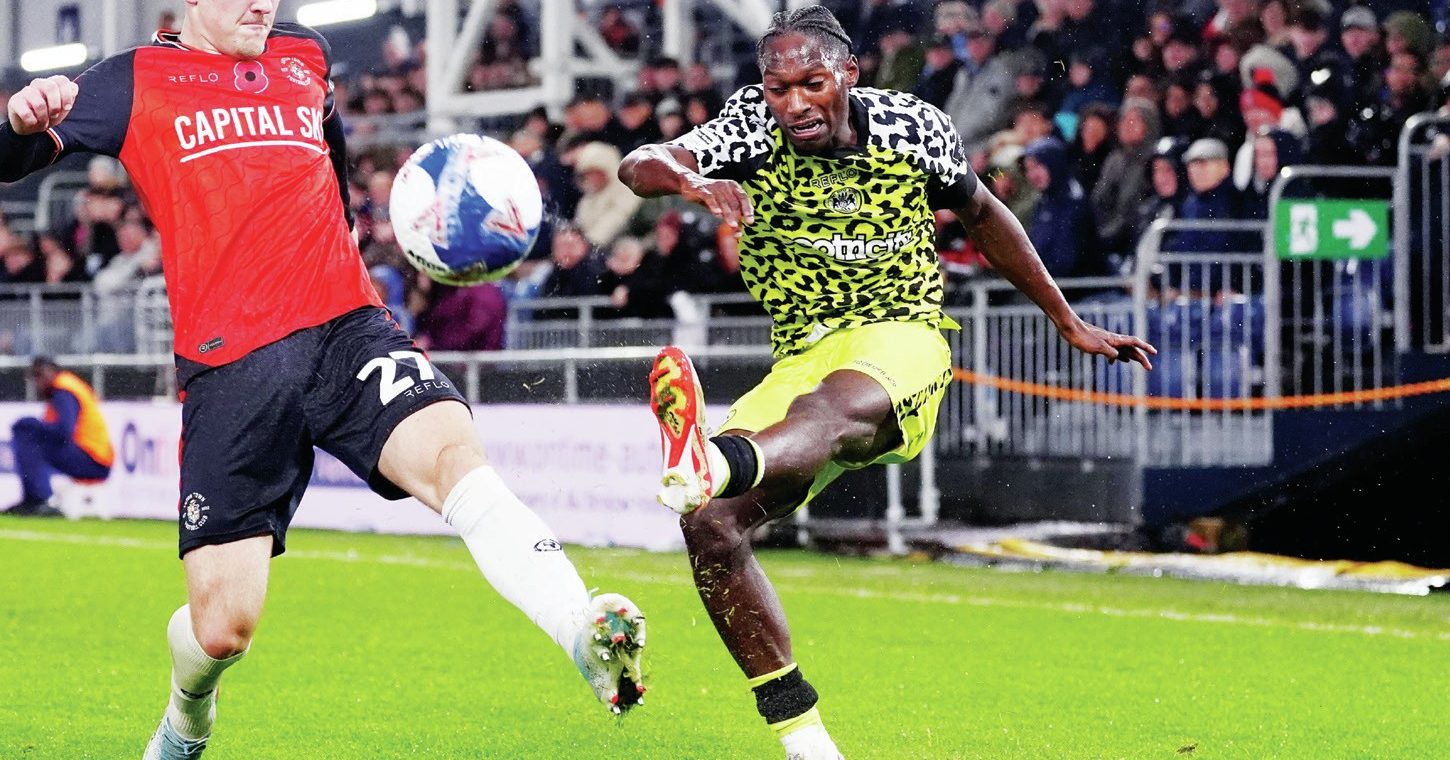 Forest Green Rovers’ Jili Buyabu swings in a cross under pressure from Luton Town’s Jake Richards