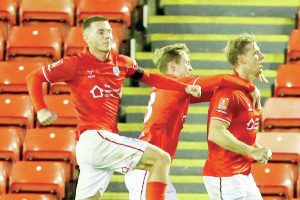 Marc Roberts, right, wheels away after scoring Barnsley’s winner