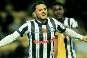 Tyler Smith wheels away after his brace helped continue Rochdale’s title charge