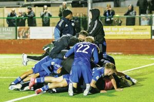 Connor Kirby celebrates scoring Buxton’s late winner against Chatham and is mobbed by team mates