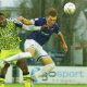 Forest Green Rovers' Temi Babalola, left, and Wealdstone’s Connor McAvoy battle in the rain