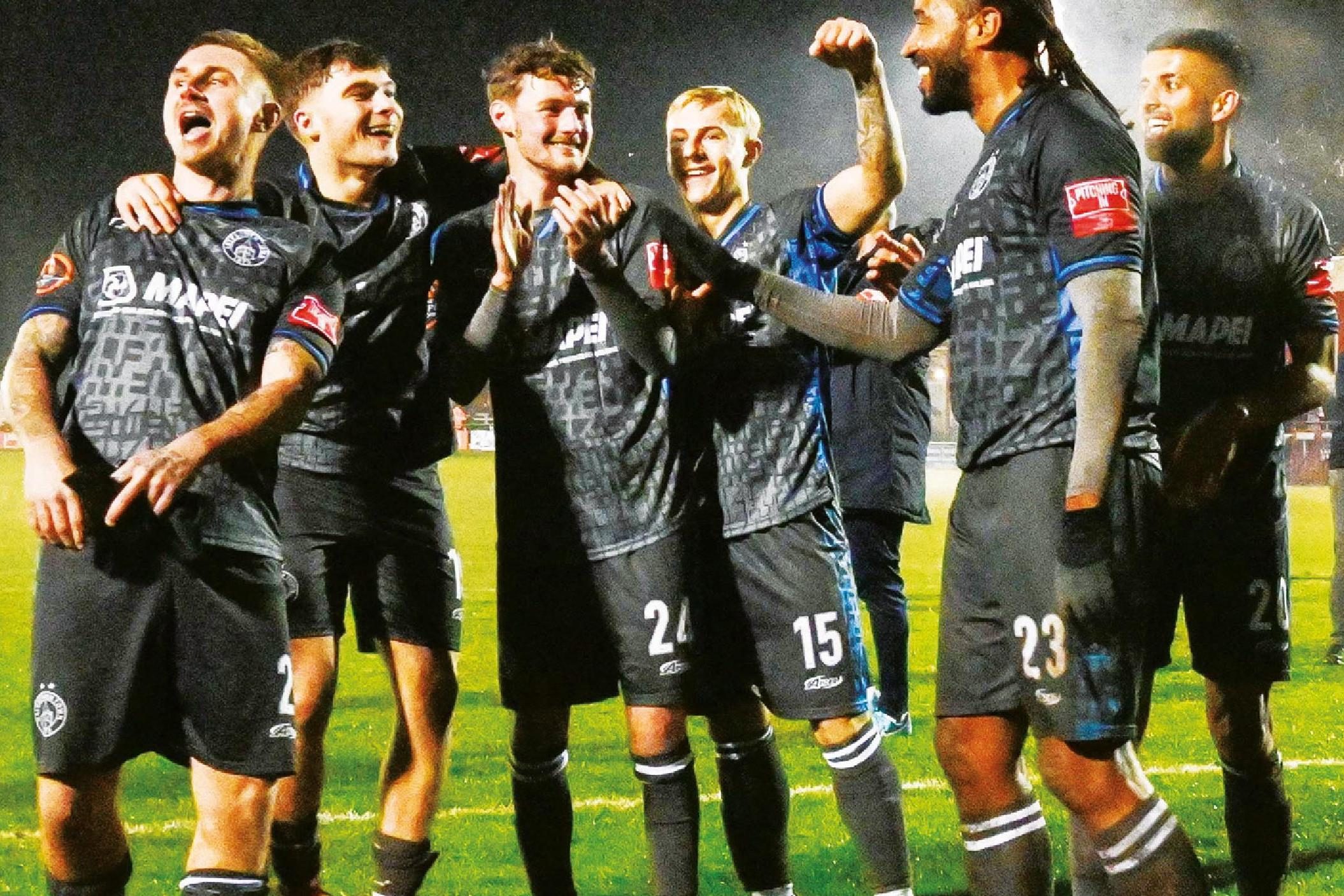 Halesowen Town players celebrate with supporters