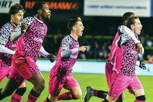 Forest Green Rovers midfielder Kyle McAllister runs away in celebration after making it 2-1