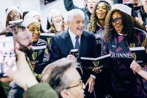 Kevin Keegan enjoys a pint while joining in with the carollers at Scunthorpe United, and inset
