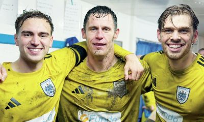 Nelson FC trio, L-R, Max Cane, Billy Priestley, and Finley Devenney celebrate victory over Ramsbottom in the last round