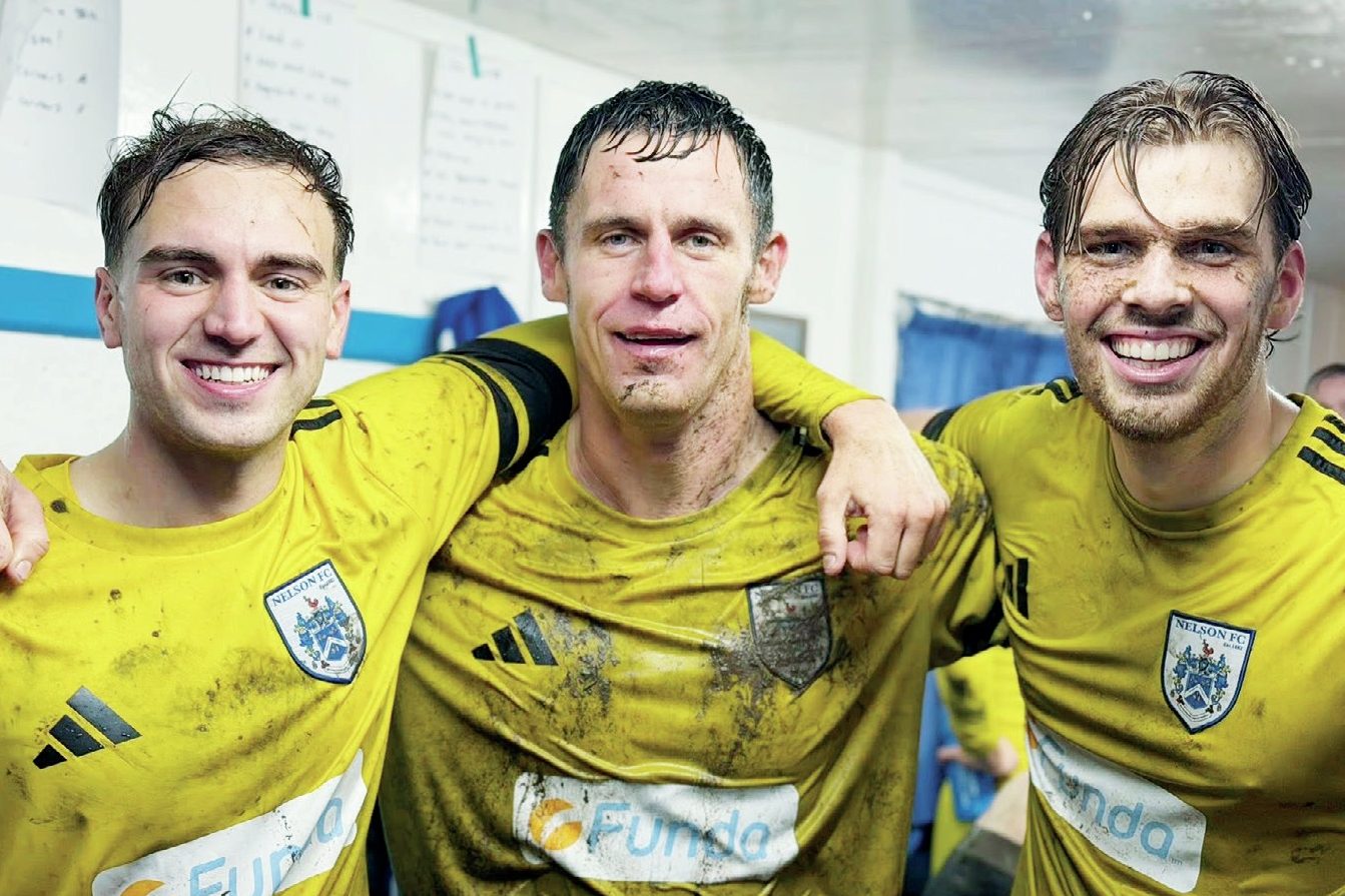 Nelson FC trio, L-R, Max Cane, Billy Priestley, and Finley Devenney celebrate victory over Ramsbottom in the last round