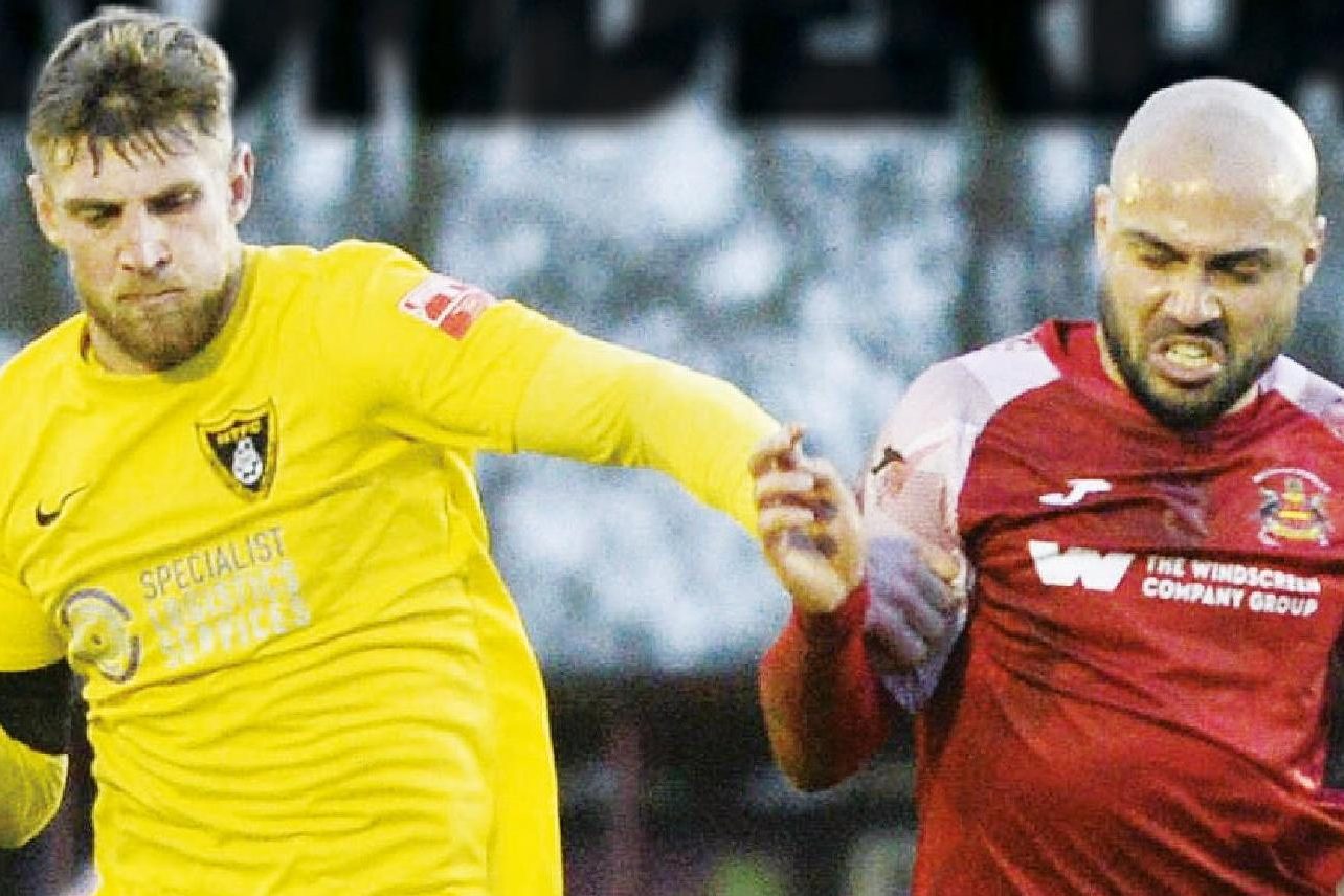 Town’s Connor Kennedy makes sure Needham Market’s Luke Ingram cannot get through