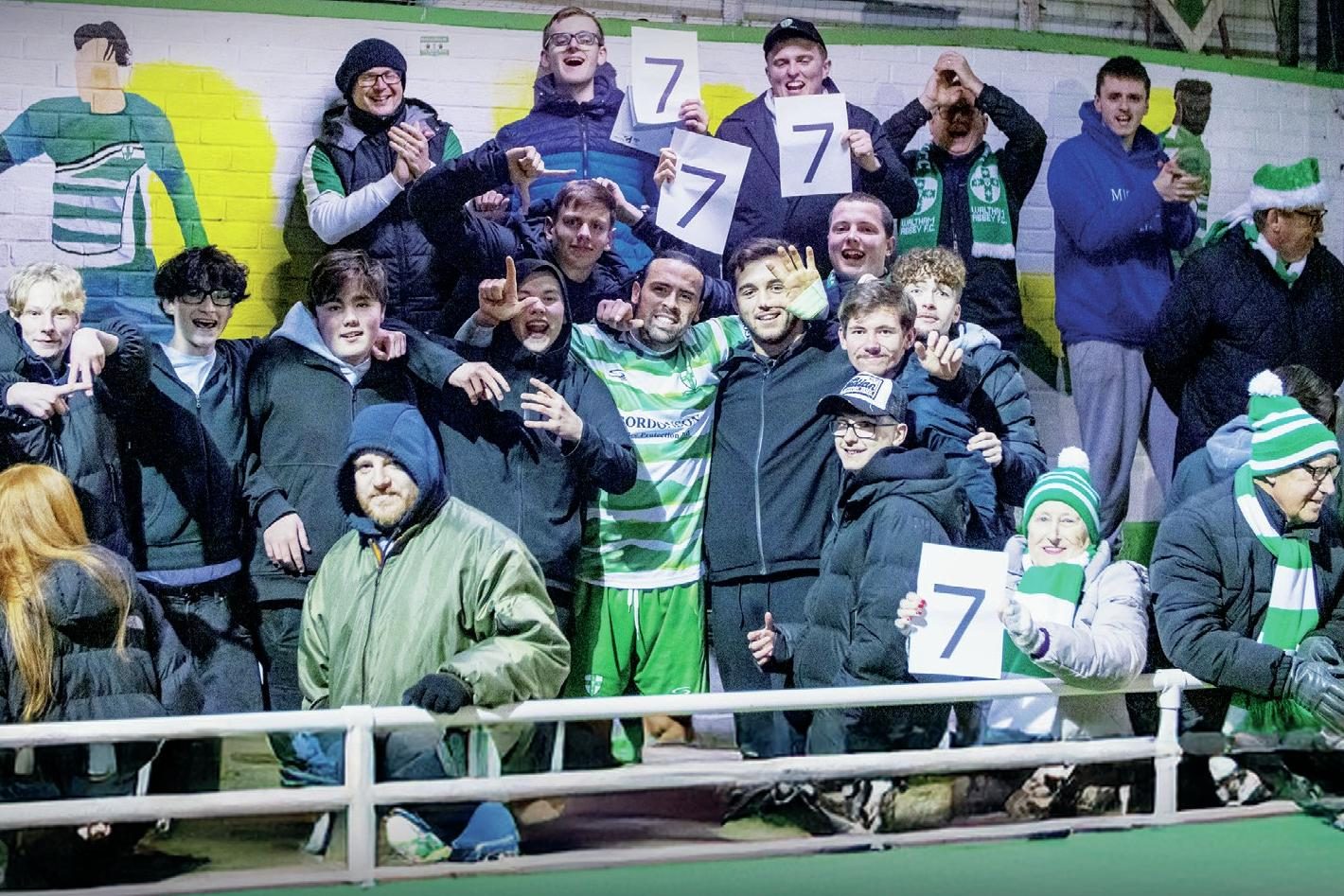 The Waltham Abbey fans celebrate their winning run with the players