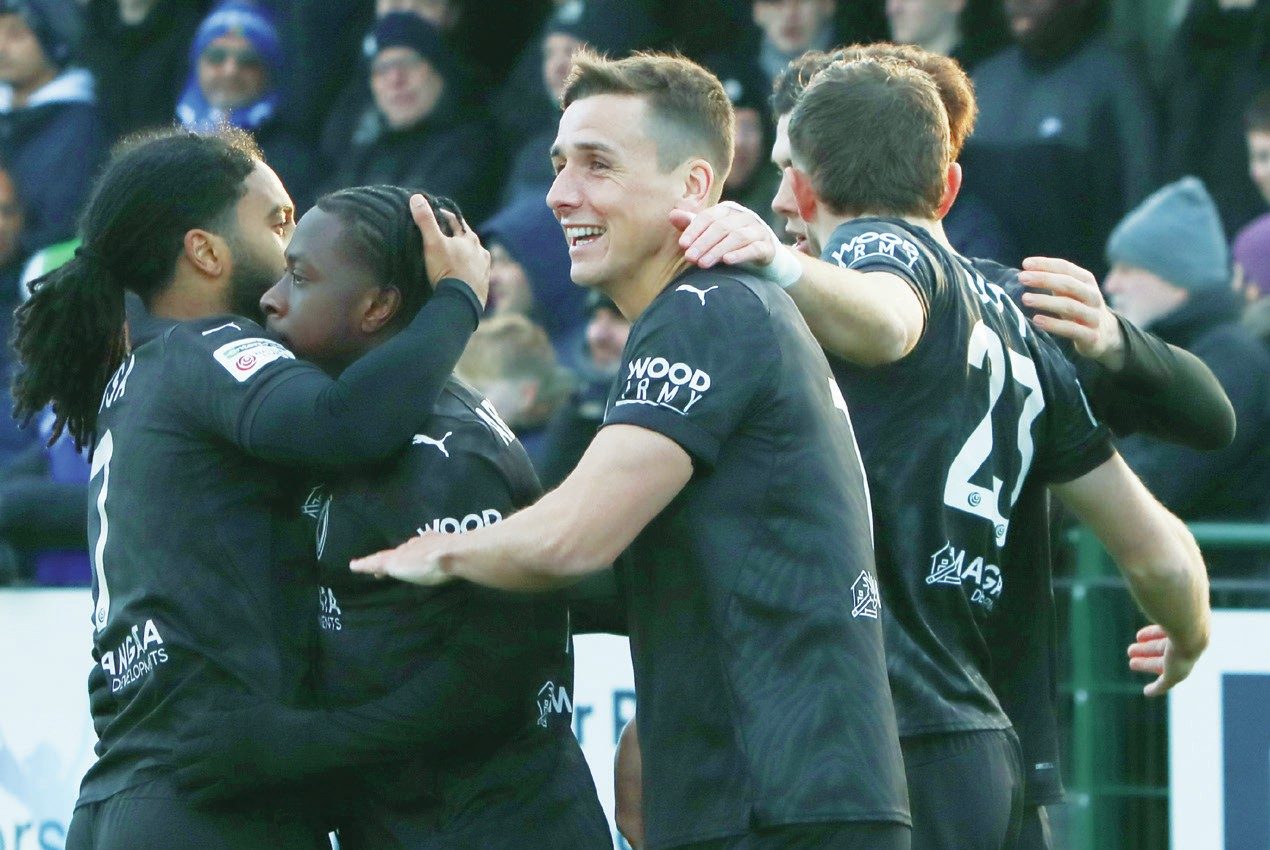 Abdul Abdulmalik, second left, is congratulated for putting Boreham Wood in front