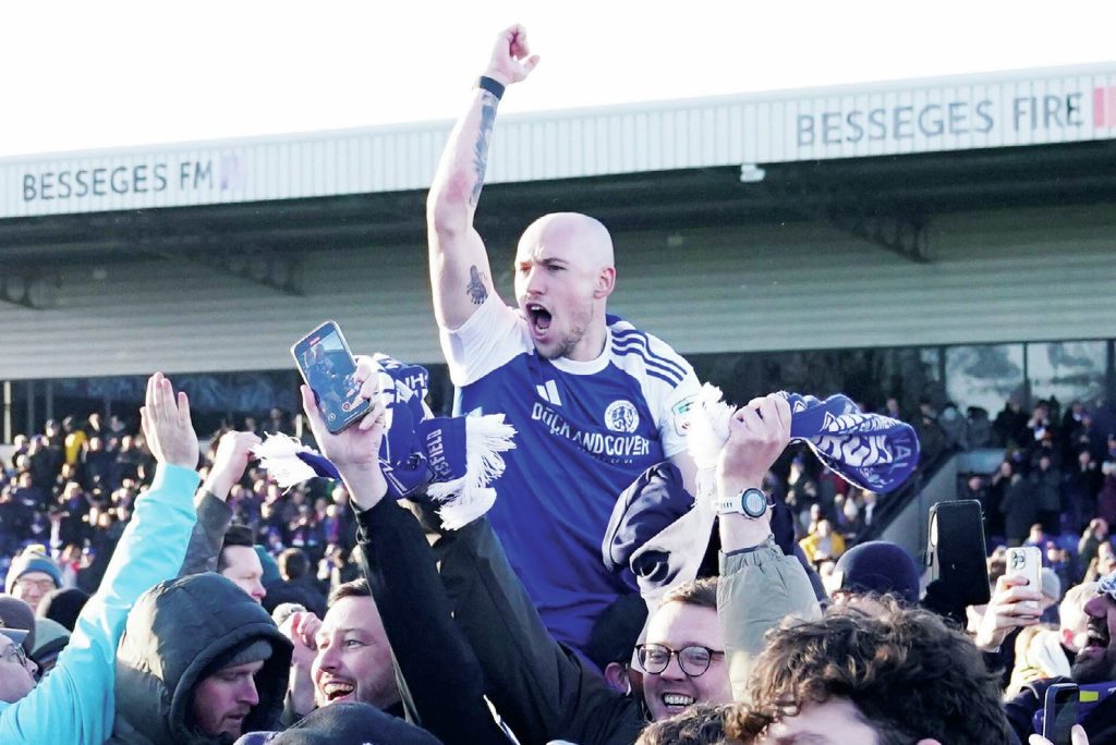 Josh Kay is held aloft by joyous Macclesfield fans after their historic victory over FA Cup holders Crystal Palace