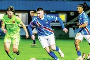 Whitby Town’s James Harrison drives forward with the ball