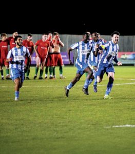 Fisher players celebrate Michael Sarpong fires home the winning spot kick and, inset, Sarpong and Christopher Ojemen enjoy the moment