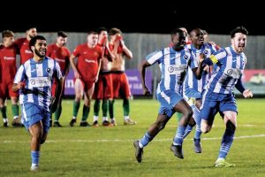 Fisher players celebrate Michael Sarpong fires home the winning spot kick and, inset, Sarpong and Christopher Ojemen enjoy the moment
