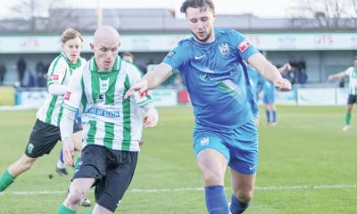Blyth Town’s Ben Fell, in blue, son of manager Gavin, challenges Blyth Spartans’ Jack Foalle in the historic derby
