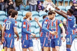 Ryan Galvin, centre, is congratulated by his Carlisle United team-mates