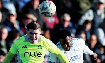 Hartlepool United’s Maxim Kouogun challenges for a header with Will Hugill of FC Halifax Town